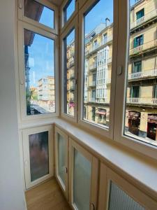 a room with windows with a view of a city at ATSEDEN apartment - Opción a parking - in San Sebastián