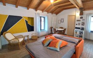 - une chambre avec un grand lit et des oreillers orange dans l'établissement [Centro Storico] Casa con Wi-Fi e Parcheggio a 100m, à Saluces