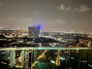 a view of a city at night with lights at Grande Cariibbean Pattaya by Thita in Pattaya South