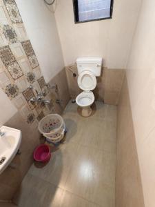 a bathroom with a toilet and a sink at Shayadri Farmhouse in Mahabaleshwar