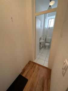 an empty bathroom with a toilet and a sink at B10-LINDE in Baden-Baden +3 photos