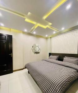 a bedroom with two beds and a ceiling fan at 102-Luxury Apartment to Admire your stay in Lahore in Lahore
