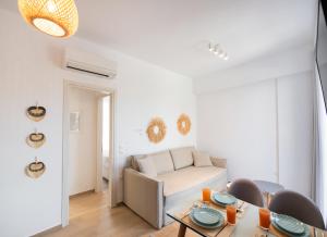 a living room with a couch and a table at SunilioS Apartments Lefkada in Lefkada Town