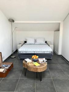 a bedroom with a bed and a table with a bowl of fruit at Appartement Duplex 4 personnes Quartier Riquier Nice in Nice