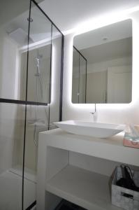 a bathroom with a white sink and a mirror at Appartement Duplex 4 personnes Quartier Riquier Nice in Nice