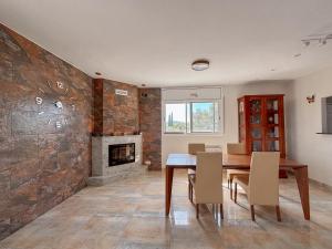a dining room with a table and a fireplace at Clauhomes Golf and Sea in Tarragona