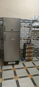 ein Kühlschrank in einer Küche mit einem Regal voller Lebensmittel in der Unterkunft أجبن نالعز in Siwa
