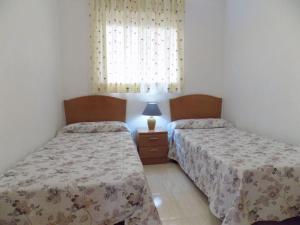 a bedroom with two beds and a window at Holiday Costa marina 3MED006 in El Borseral +32 photos