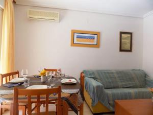 a living room with a table and a couch at Holiday Costa marina 3MED006 in El Borseral