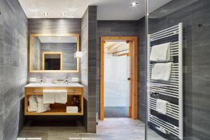 a bathroom with a sink and a shower at Huber's Boutique Hotel in Mayrhofen