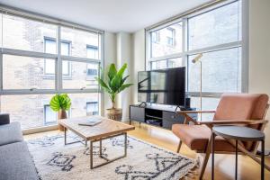 a living room with a couch and a tv at Downtown 2BR w WD nr Boston Common BOS-244 in Boston