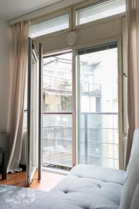 a bedroom with a large sliding glass door at 2ndhomes Kluuvi Apartment 2 in Helsinki