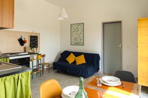 a living room with a couch and a table at Casina al Castello - Natura e Relax in Castel del Monte