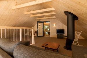 a living room with a couch and a fireplace at Minkfarmen, Spacious seaside cabin with scenic view in Ramberg