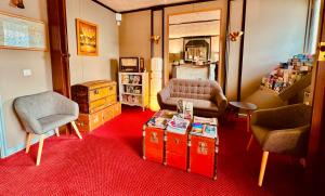 a living room with two chairs and a table at Hotel Italia in Tours