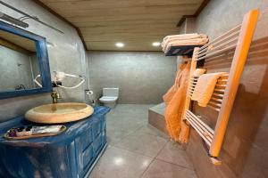 a bathroom with a sink and a toilet at Aşk-ı Nare Cave Hotel in Nevsehir