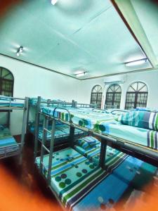a group of bunk beds in a room at Mang Ben Dormitory Kaliraya in Manila