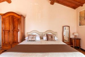 a bedroom with a large bed with two pillows at Agriturismo - Collina Toscana Resort in Monsummano Terme