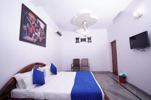 a bedroom with a bed and a tv in it at Hotel Lecston @Yashobhoomi Dwarka Sector - 25 metro station in New Delhi