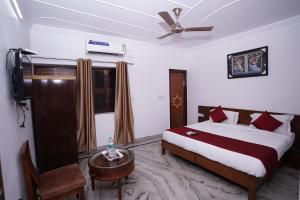 a bedroom with a bed and a television in it at Hotel Lecston @Yashobhoomi Dwarka Sector - 25 metro station in New Delhi