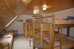 a room with several bunk beds in a cabin at PUS Bavšica in Log pod Mangartom +12 photos