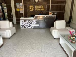 a lobby with two white chairs and a counter at Dayal International - New Digha in Digha