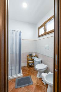 a bathroom with two toilets and a shower at VERY WELL apartment in Porto Torres