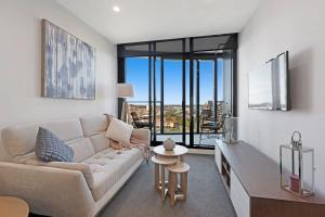 a living room with a couch and a table at Parque on St Kilda - 02532 in Melbourne