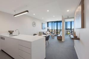 a kitchen and living room with a view of a living room at Parque on St Kilda - 02532 in Melbourne