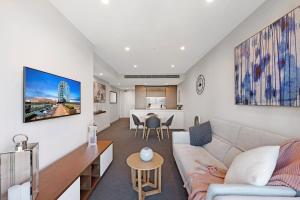 a living room with a couch and a table at Parque on St Kilda - 02532 in Melbourne +5 photos