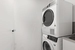 a microwave and a washing machine in a kitchen at Parque on St Kilda - 02532 in Melbourne