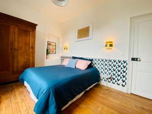 a bedroom with a blue bed with two pillows at *Belle Epoque* residence between Sologne and Berry in Mennetou-sur-Cher +61 photos