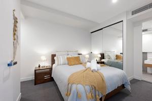 a bedroom with a bed and a large mirror at Parque on St Kilda - 02532 in Melbourne