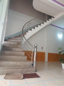 a staircase with a glass railing in a building at Tùy Anh Hostel in Mù Cang Chải