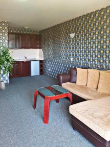 a living room with a couch and a coffee table at Twins Palace ApartHotel in St. St. Constantine and Helena