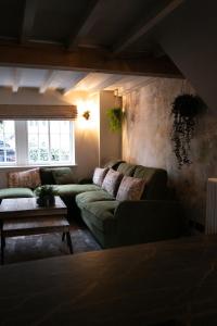 Akasha Spa Retreat Cottage في Welton: غرفة معيشة مع كنبتين وطاولة