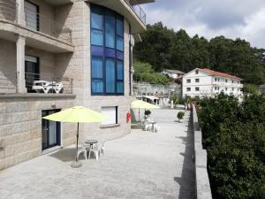 two yellow umbrellas sitting outside of a building at APARTAMENTOS CANADA 2 in Raxó