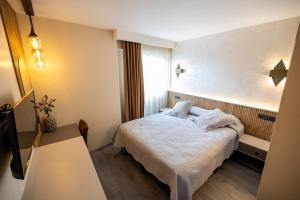 Postel nebo postele na pokoji v ubytování Aktas Hotel