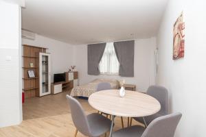 a living room with a table and chairs at Apartments Marsela in Tučepi