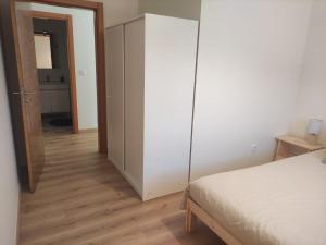 ein Schlafzimmer mit einem weißen Schrank und einem Bett in der Unterkunft T1 Casa da Quinta in Mafra