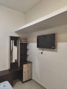 A television and/or entertainment centre at Nostaligia Homestay,wayanad