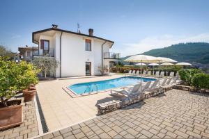 a villa with a swimming pool in front of a house at Ca' Le Terrazze With Pool in Garda