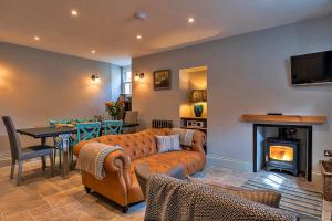 a living room with a couch and a fireplace at Finest Retreats - Potters Cottage in Fowey