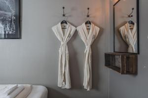 a couple of shirts hanging on a wall at Coal Miners’ Cabins in Longyearbyen