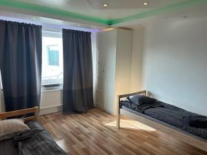 Schlafzimmer mit einem Bett und einem Fenster mit Vorhängen in der Unterkunft Davids Hotell in Alvesta