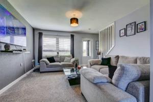 a living room with two couches and a table at Ardfin Road - Prestwick The Open in Prestwick