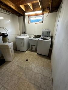 a small bathroom with two sinks and two toilets at Budget Stay in Kitchener- Near Town Centre- Food, Shopping, Transit K3 in Kitchener