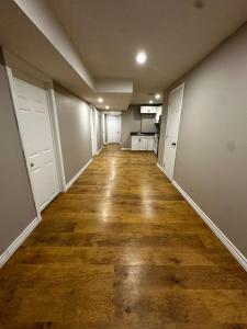 an empty hallway of an apartment with a hard wood floor at Budget Stay in Kitchener- Near Town Centre- Food, Shopping, Transit in Kitchener