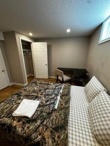 a bedroom with a bed and a table and a chair at Budget Stay in Kitchener- Near Town Centre- Food, Shopping, Transit K3 in Kitchener