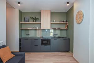 a kitchen with a counter top in a room at Design apartments between National Art Museum and Arena Riga in Rīga